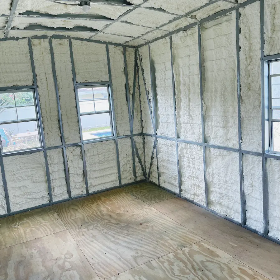 Closed-cell spray foam insulation applied to wall cavities in a residential project in Plainsboro